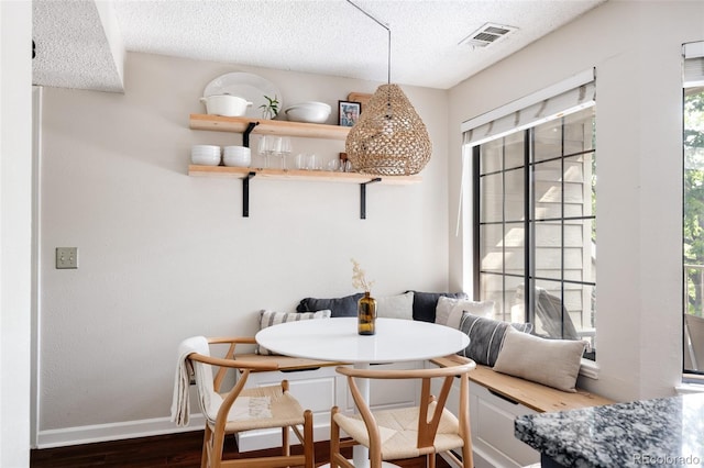 dining room with plenty of natural light, dark wood-type flooring, and breakfast area