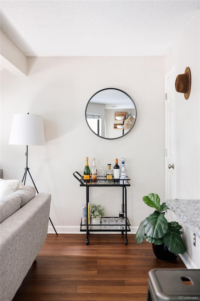 interior space with dark wood-type flooring and a textured ceiling