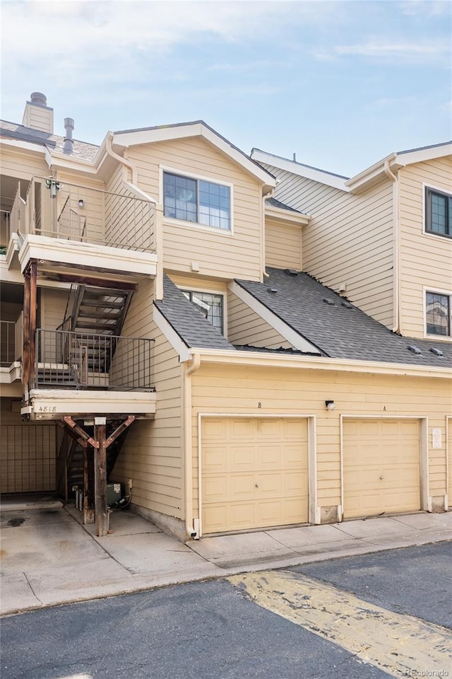 view of front of home featuring a balcony and a garage