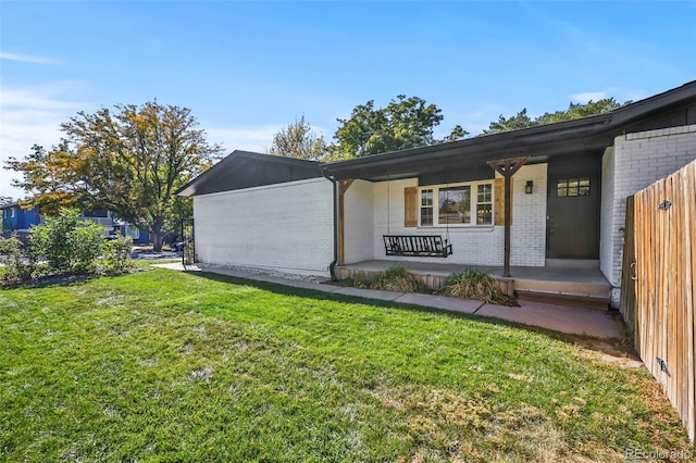 exterior space with covered porch and a yard