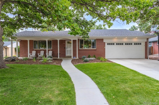 view of front of property with a garage, a porch, and a front lawn