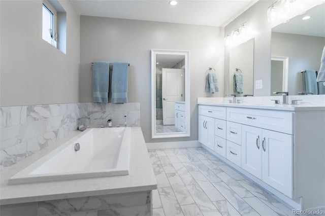 bathroom featuring vanity and a washtub