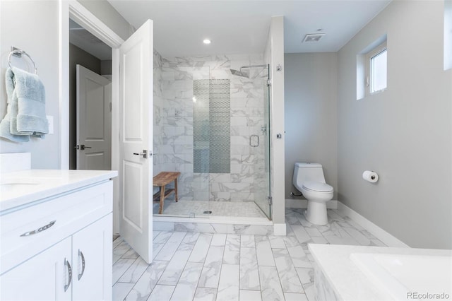 bathroom featuring vanity, a shower with shower door, and toilet