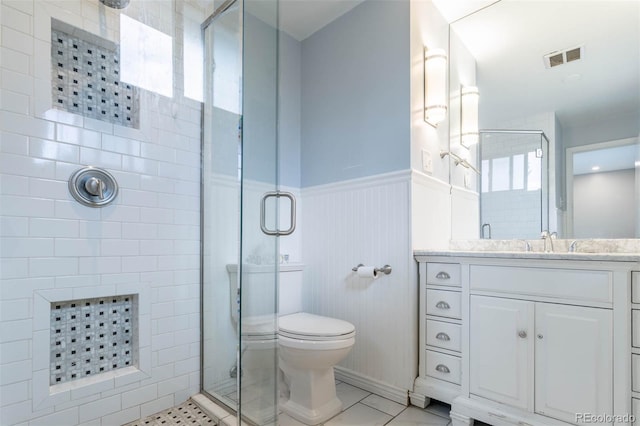 bathroom featuring vanity, a shower with door, and toilet