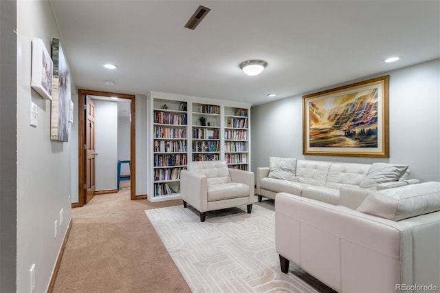 living room with light carpet and built in shelves