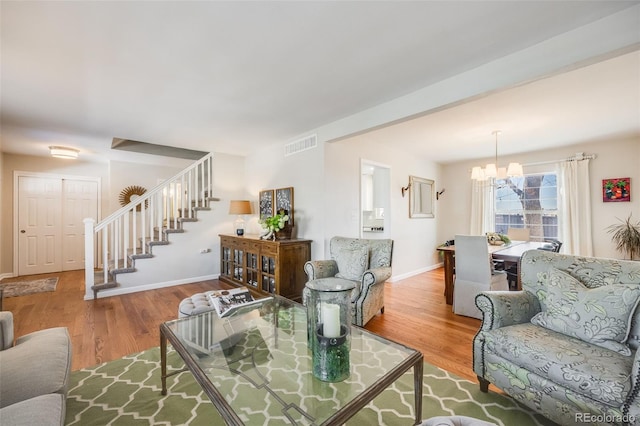 living room featuring hardwood / wood-style flooring and a chandelier