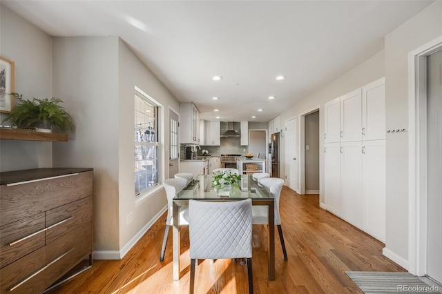 dining space with light wood-type flooring