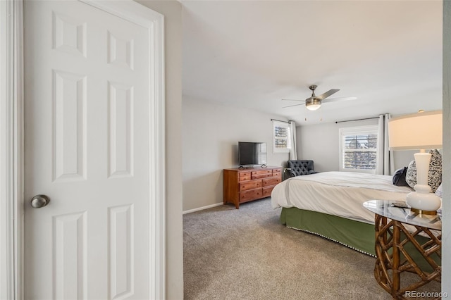 bedroom featuring ceiling fan and light carpet