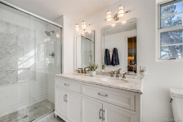 bathroom with vanity, a shower with shower door, and toilet