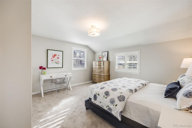 bedroom featuring vaulted ceiling and carpet