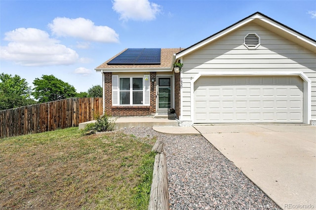 7830 Club Crest Dr, Arvada, CO 80005 - ranch-style home featuring brick siding, driveway, roof mounted solar panels, a garage, and a shingled roof