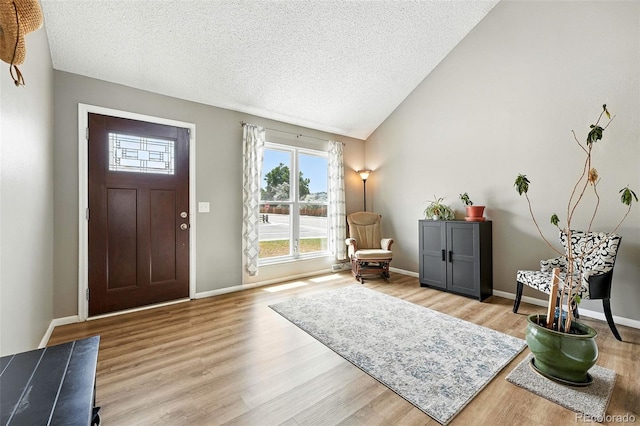 7830 Club Crest Dr, Arvada, CO 80005 - foyer featuring light wood-type flooring, a textured ceiling, and lofted ceiling