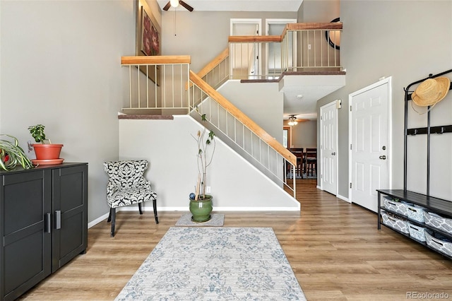 7830 Club Crest Dr, Arvada, CO 80005 - entrance foyer with ceiling fan, stairway, and wood finished floors