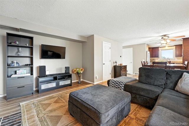 7830 Club Crest Dr, Arvada, CO 80005 - living room with wood finished floors, a textured ceiling, and a ceiling fan