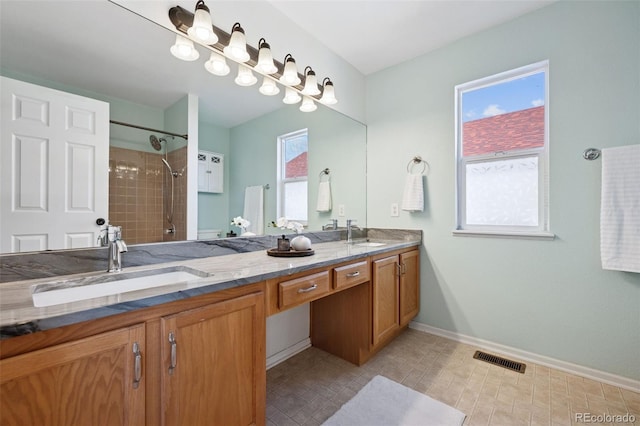 full bath featuring plenty of natural light, visible vents, and a sink