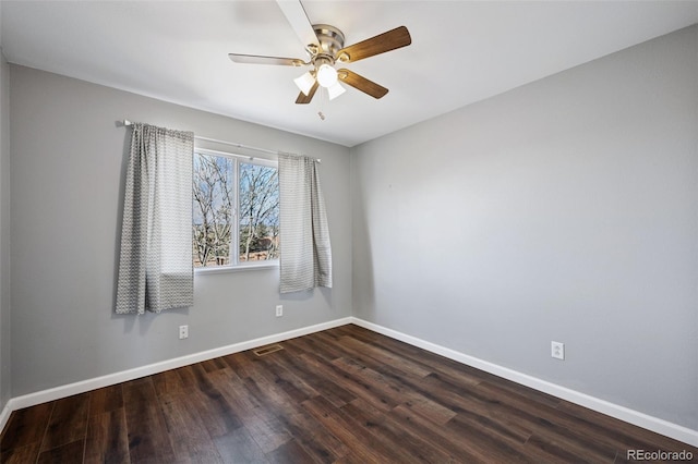 spare room with visible vents, baseboards, ceiling fan, and wood finished floors