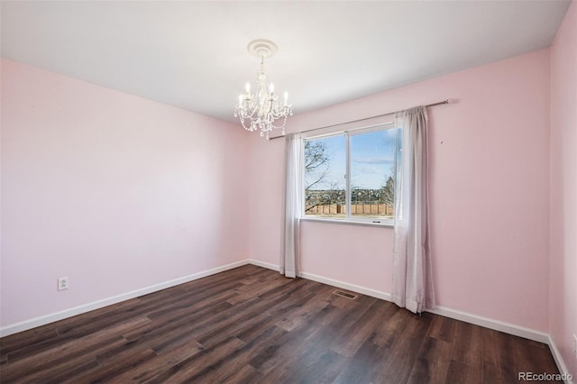 unfurnished room with a chandelier, dark wood-style flooring, visible vents, and baseboards