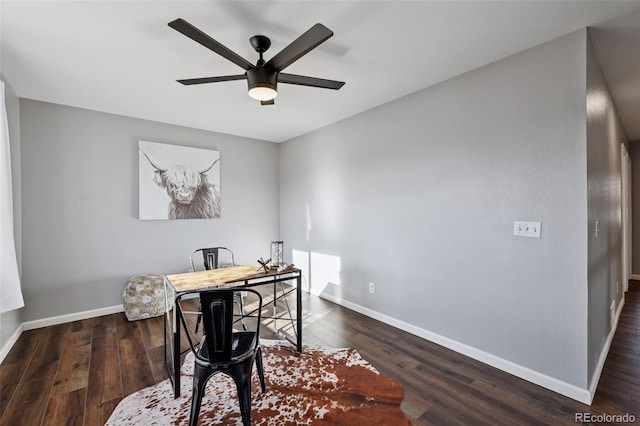 office area with a ceiling fan, dark wood finished floors, and baseboards