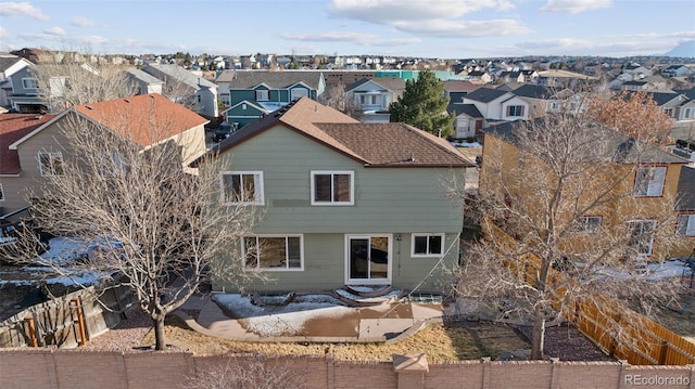 back of property with a residential view, a fenced backyard, and a patio