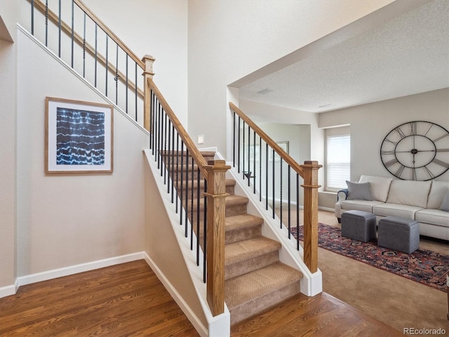 stairway featuring baseboards and wood finished floors