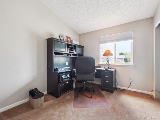 office space featuring light colored carpet, a textured ceiling, and baseboards