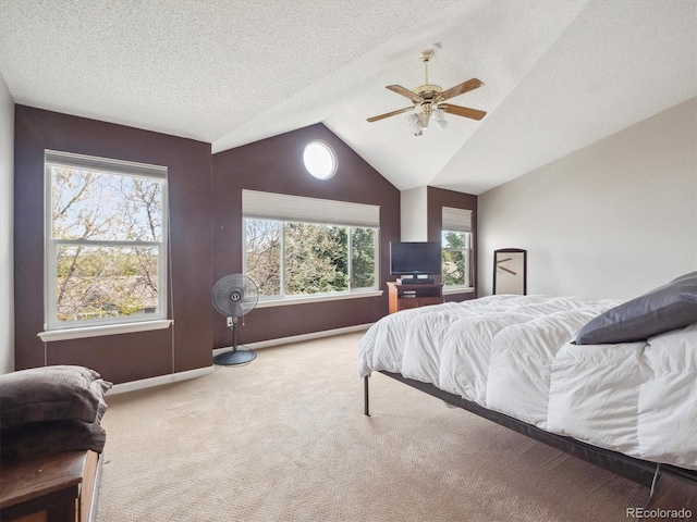 bedroom with a ceiling fan, a textured ceiling, baseboards, lofted ceiling, and carpet