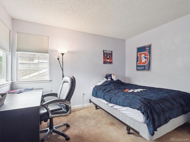bedroom featuring baseboards, carpet flooring, and a textured ceiling