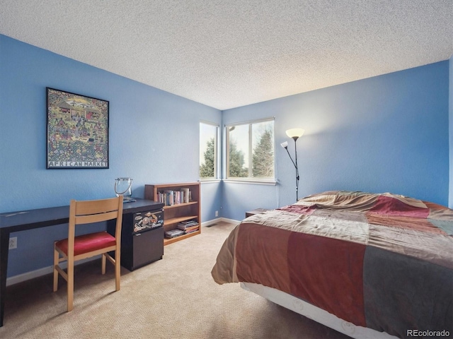 carpeted bedroom featuring baseboards and a textured ceiling