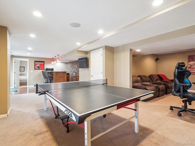 recreation room featuring bar area, baseboards, light carpet, and recessed lighting