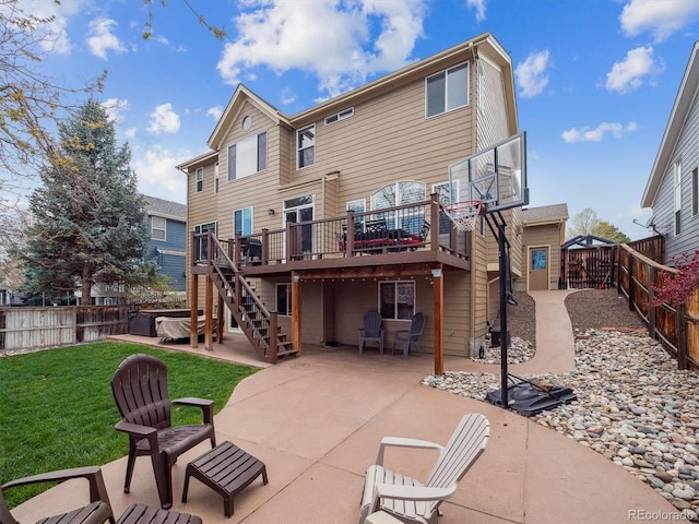 rear view of house with stairs, a deck, a fenced backyard, a patio area, and a yard