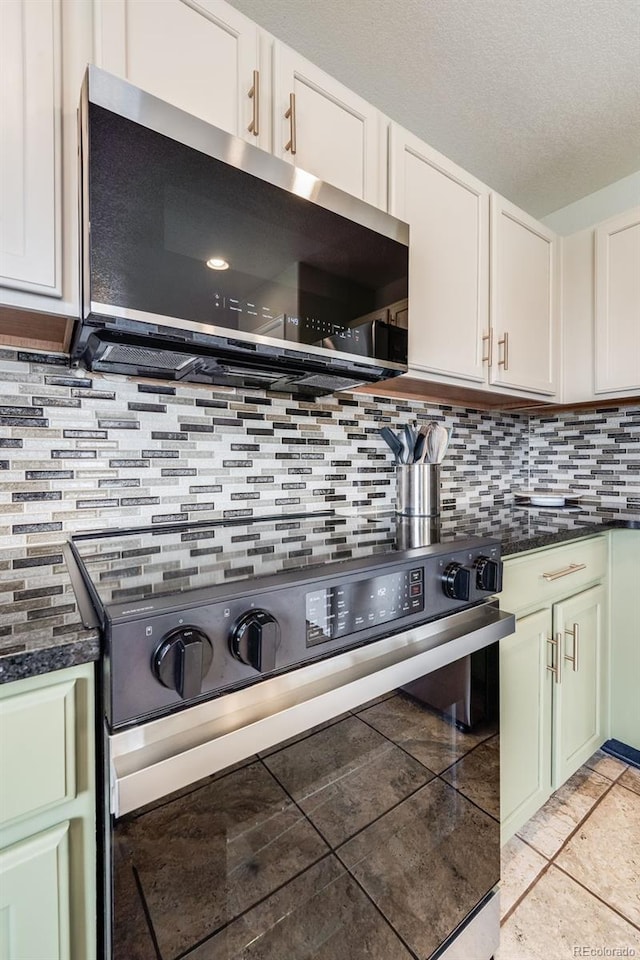 kitchen featuring tasteful backsplash, white cabinetry, appliances with stainless steel finishes, and a textured ceiling