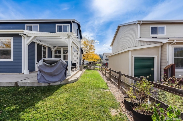 rear view of house with a yard and a pergola