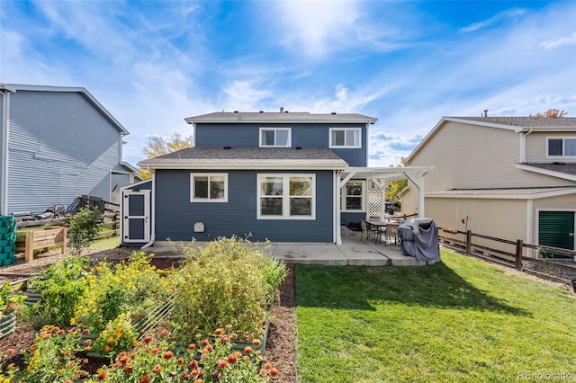 back of house featuring a patio, a yard, and a pergola