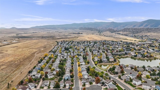 birds eye view of property featuring a water and mountain view