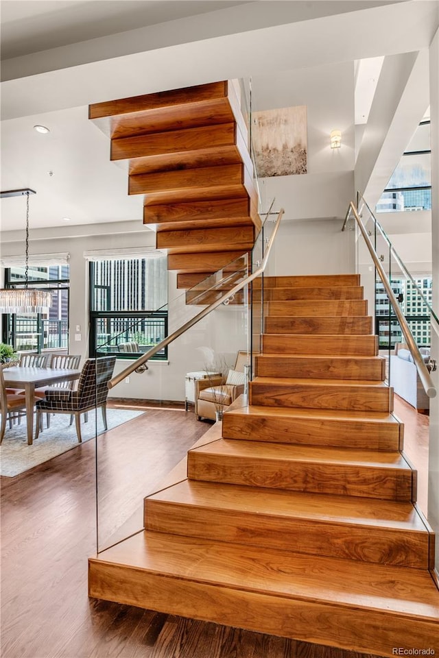 stairs featuring hardwood / wood-style floors