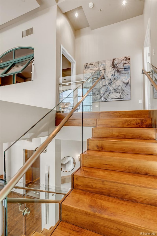 stairway featuring a high ceiling