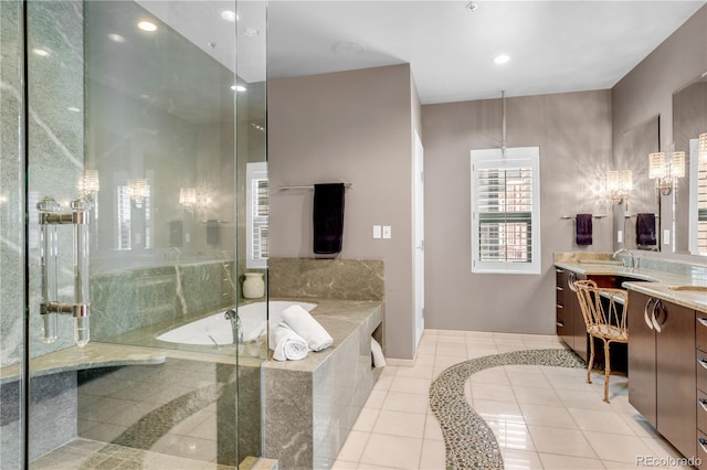 bathroom with vanity, tile patterned flooring, and tiled tub