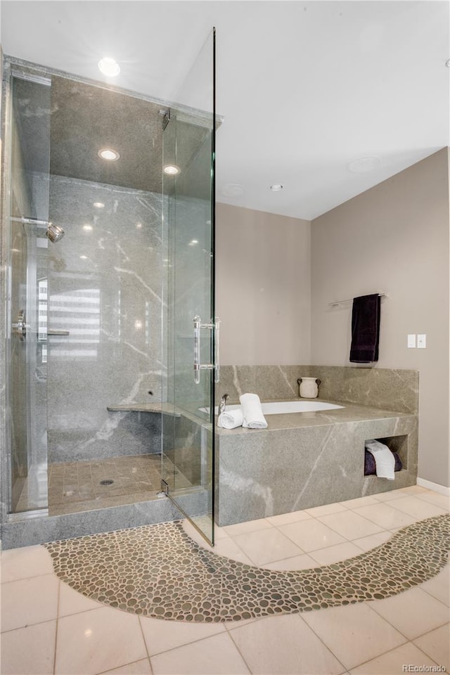 bathroom featuring separate shower and tub and tile patterned flooring