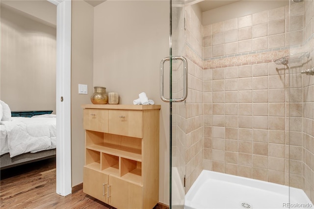 bathroom featuring a shower with door and hardwood / wood-style floors