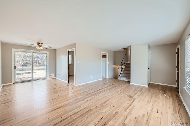 unfurnished living room featuring ceiling fan and light wood-type flooring