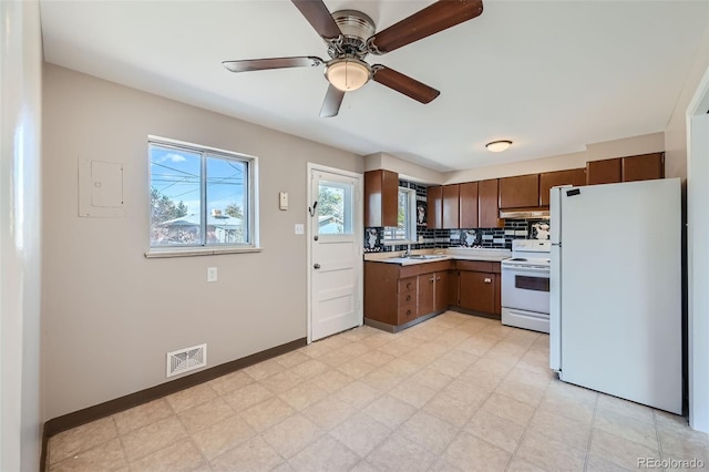 kitchen with white appliances, ceiling fan, decorative backsplash, and sink