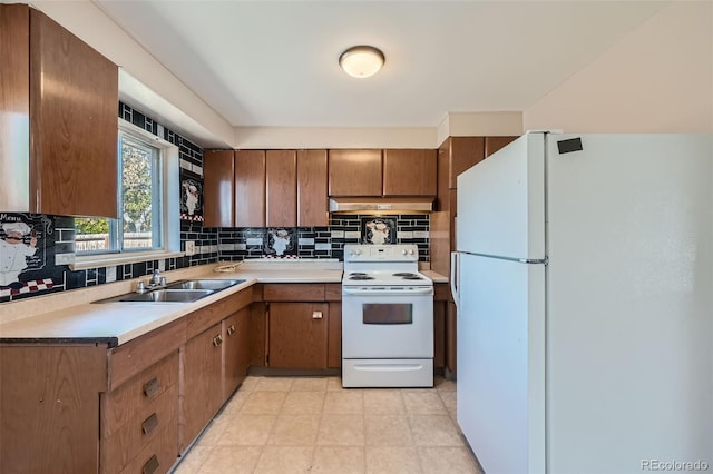 kitchen featuring tasteful backsplash, sink, and white appliances