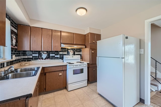 kitchen with sink, backsplash, and white appliances