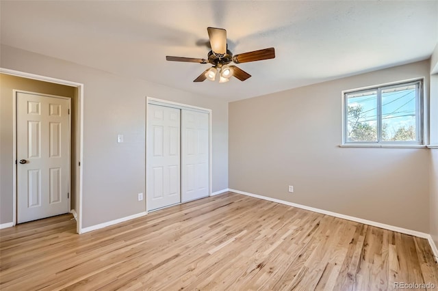 unfurnished bedroom featuring light hardwood / wood-style floors, a closet, and ceiling fan