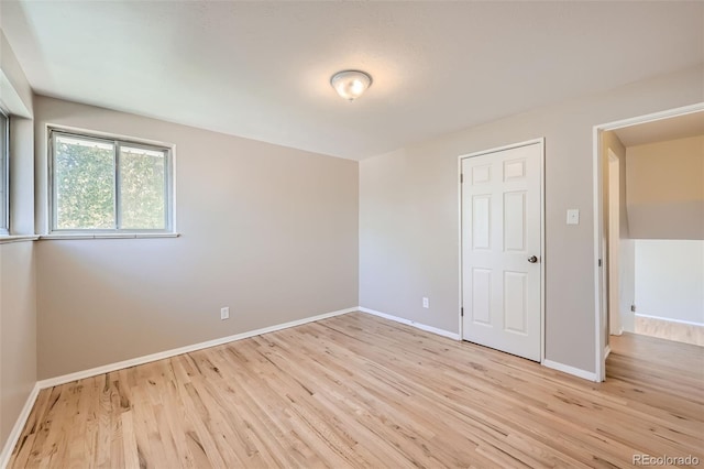 spare room with light hardwood / wood-style flooring