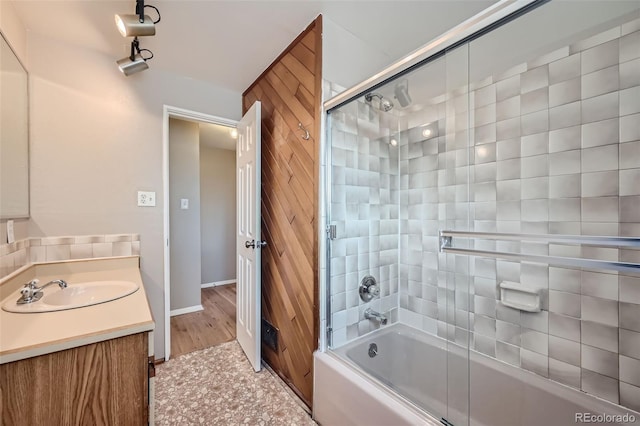 bathroom with vanity, shower / bath combination with glass door, and hardwood / wood-style flooring