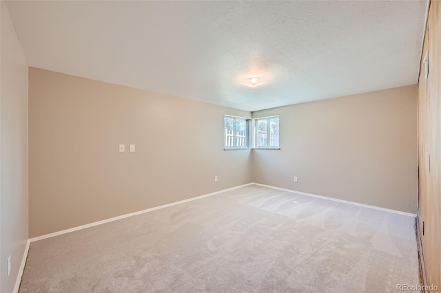 carpeted spare room with a textured ceiling