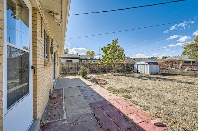 view of yard featuring a shed and a patio