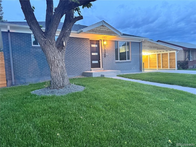7126 Joan St, Denver, CO 80221 - single story home featuring a front yard and brick siding