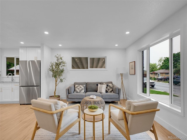 7126 Joan St, Denver, CO 80221 - living area with recessed lighting, plenty of natural light, light wood-type flooring, and baseboards